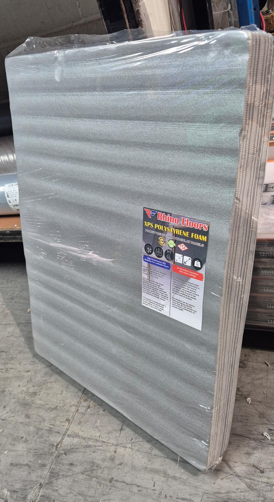 Stack of foam panels with a label on a concrete floor