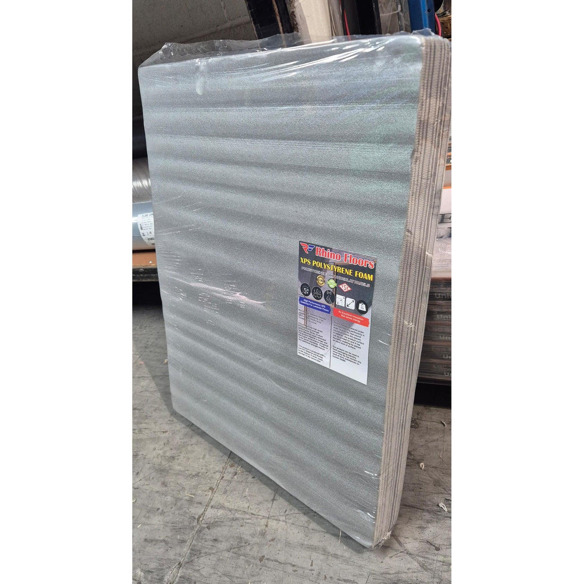 Stack of foam panels with a label on a concrete floor