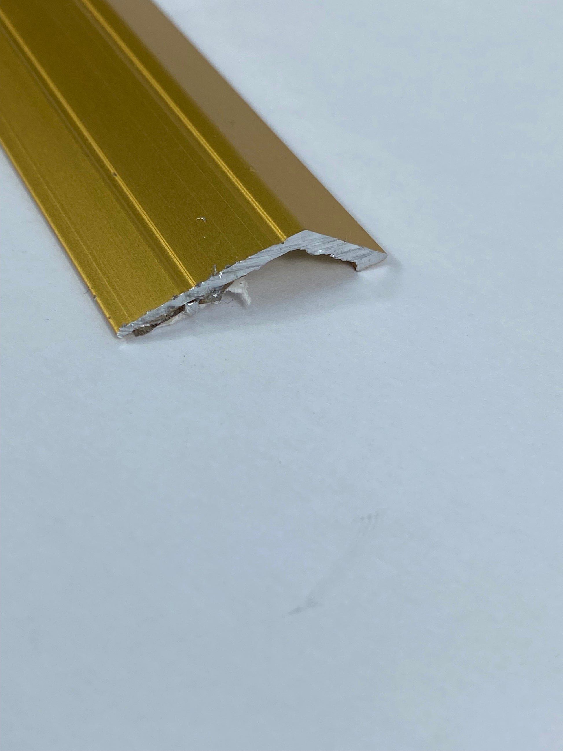 A gold-colored metal doorplate 