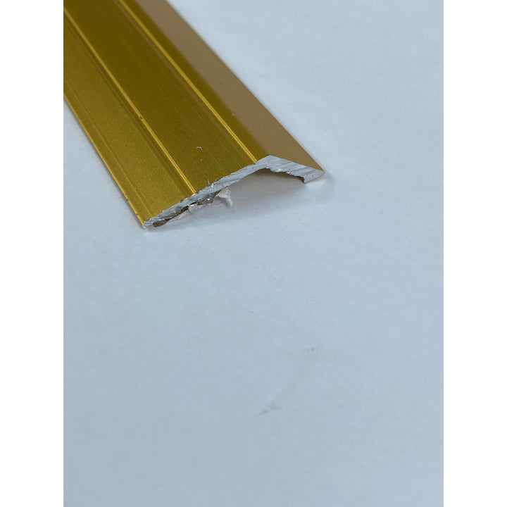 A gold-colored metal doorplate 